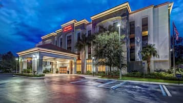 Welcome to Hampton Inn & Suites, featuring a contemporary entrance with a canopy and ample parking.