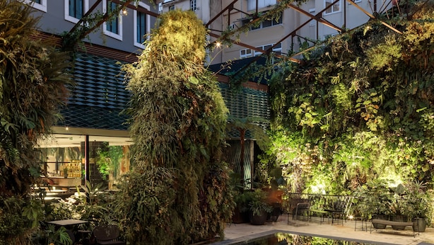 An indoor pool area with a glass ceiling, surrounded by lush greenery and modern furniture. - Hotel X Hotel Avenida Liberdade, a Member of Design Hotels (Lisbon)