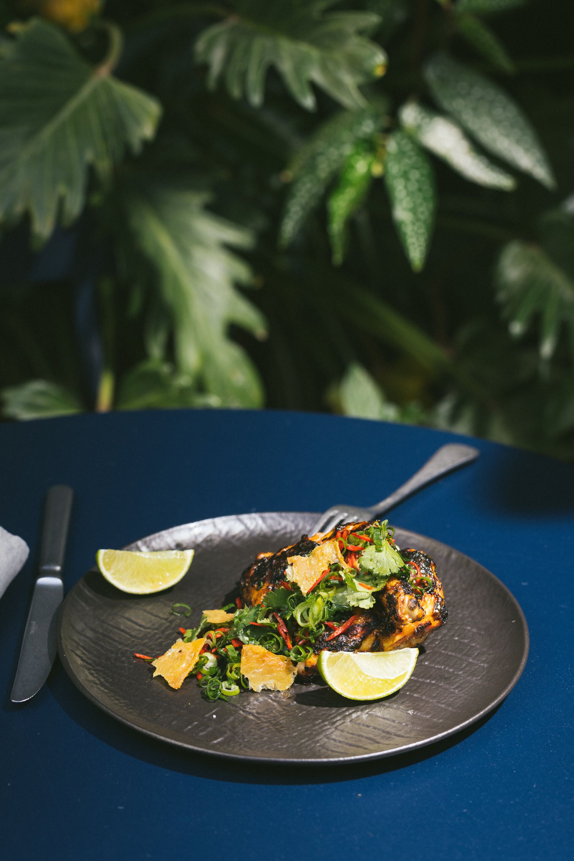 A plate of food with a fork and knife on a table.