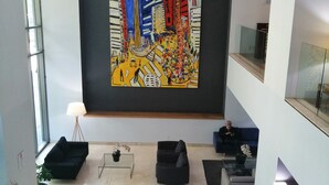 A spacious lobby with a large abstract painting, comfortable seating, and a modern design. - Holiday Inn Express Mexico Reforma by IHG (Mexico City)