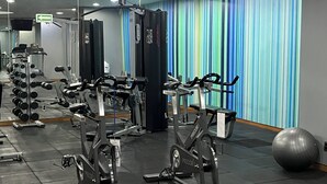 A gym with various exercise equipment, including treadmills and weight machines, and a large exercise ball. - Holiday Inn Express Mexico Reforma by IHG (Mexico City)