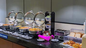 A buffet with various food items and a toaster.