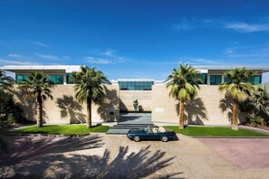 A modern building with a car parked in front.