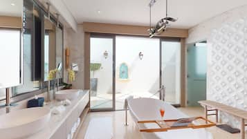 A modern bathroom with a large bathtub, two sinks, and a large mirror.