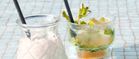 Two drinks on a tiled surface.