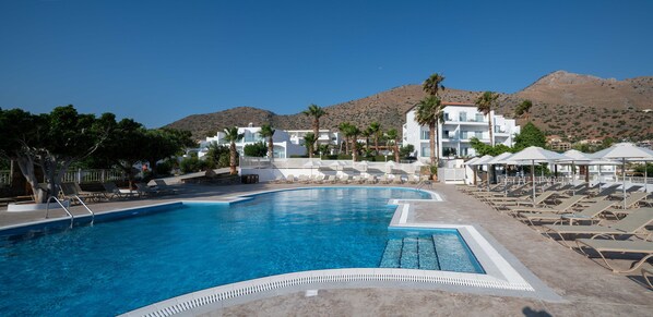 Seasonal outdoor pool, open 10:00 AM to 6:00 PM, pool umbrellas