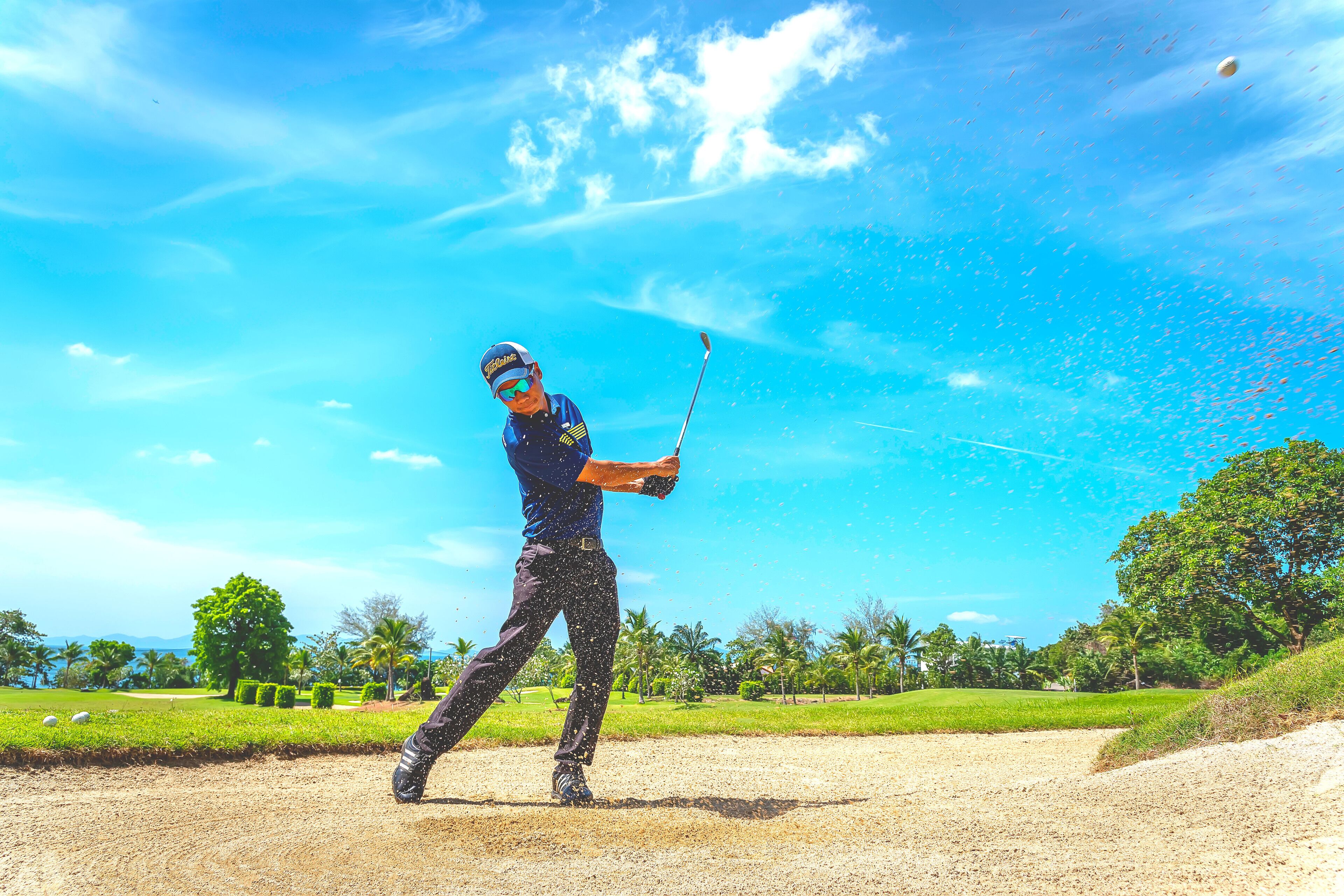 A person playing golf on a sunny day.