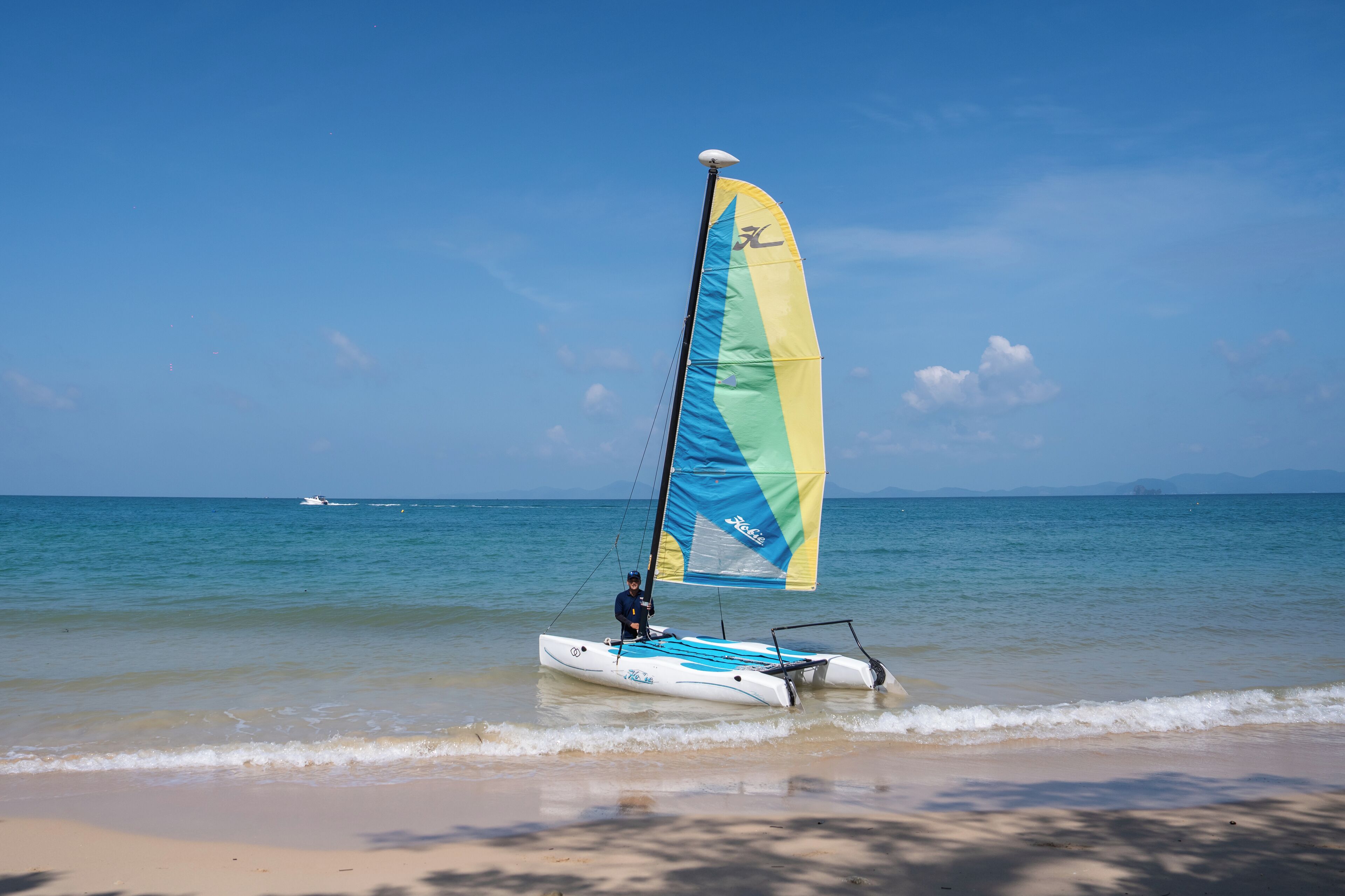 on the beach, beach towels, motor boating