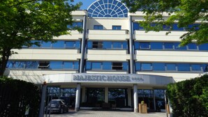 A multi-story building with a prominent glass dome on the top floor, a sign reading "MAJESTY HOUSE," and a paved entrance area with a car parked in front. - MajesticHouse Conference & Restaurant (Castenedolo)