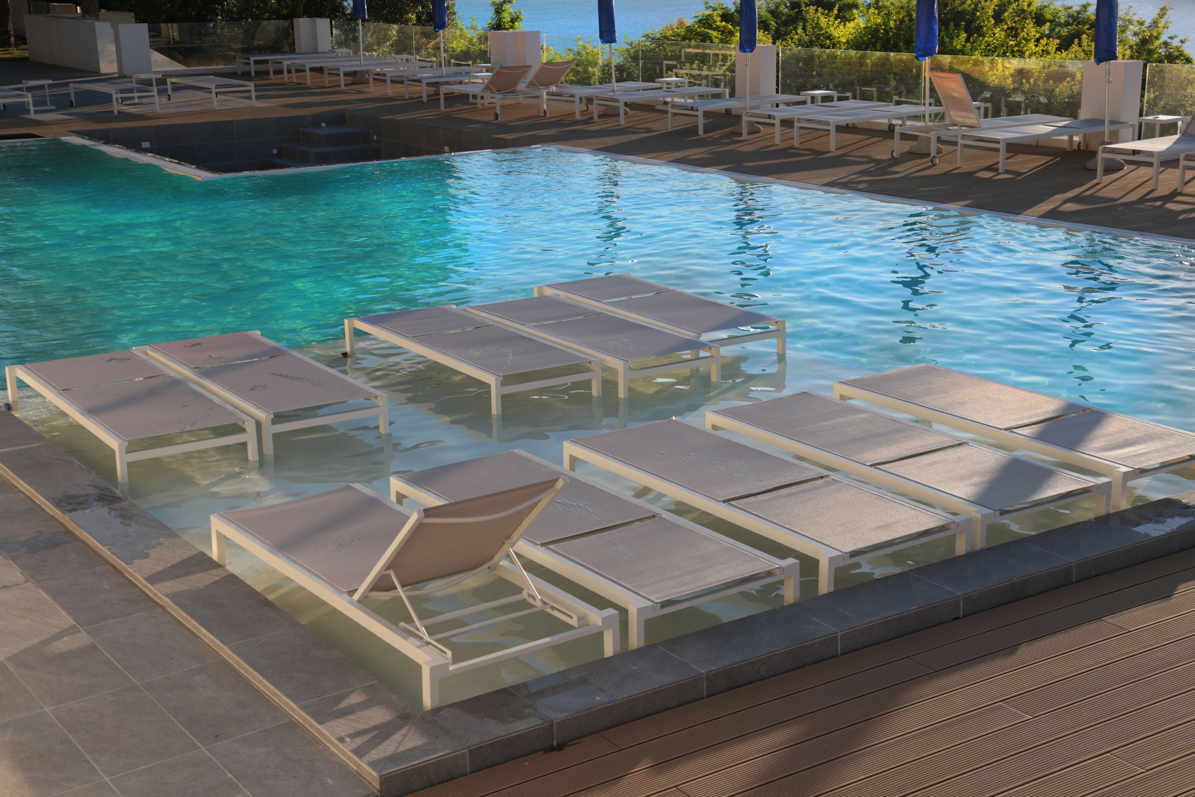 seasonal outdoor pool, pool umbrellas, pool loungers
