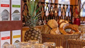 A breakfast buffet with bread, pastries, and a pineapple centerpiece. - Landgasthof Hotel Hirsch (Lossburg)