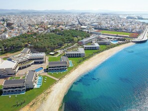 An aerial view of a coastal hotel with multiple buildings, a beach, and a clear blue sea. - Grecotel Egnatia (Alexandroupoli)