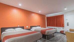 A hotel room with two beds, a desk, and a chair. - Motel 6 Barstow, CA - Route 66 (Barstow)