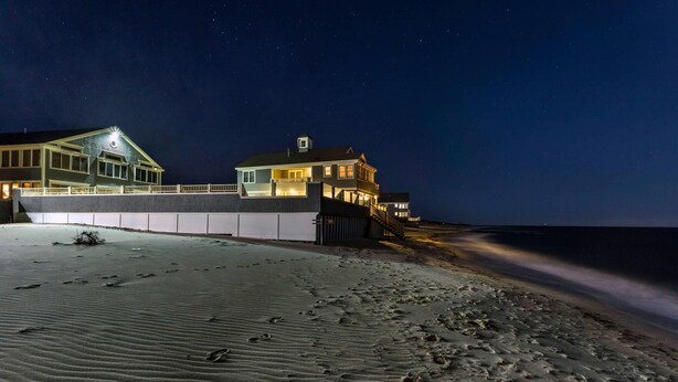 A beachfront property with a large house, a covered walkway, and a sandy beach. - Bluegreen Vacations The Breakers Resort, an Ascend Collection Resort (Dennis Port)