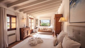 Une pièce comprenant un lit, un canapé, une armoire en bois et une fenêtre donnant sur un beau paysage.
