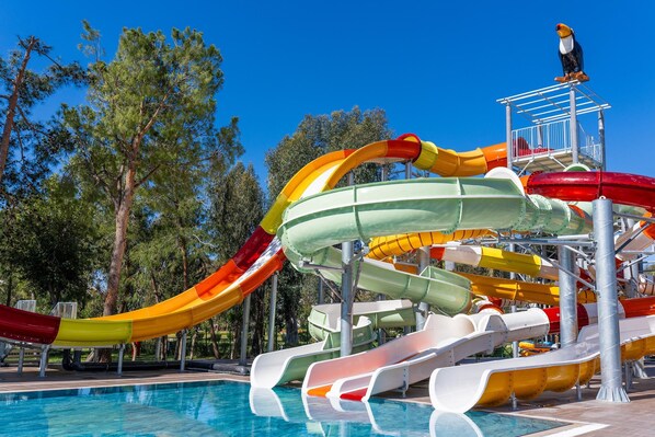 A water park with multiple slides and a pool.