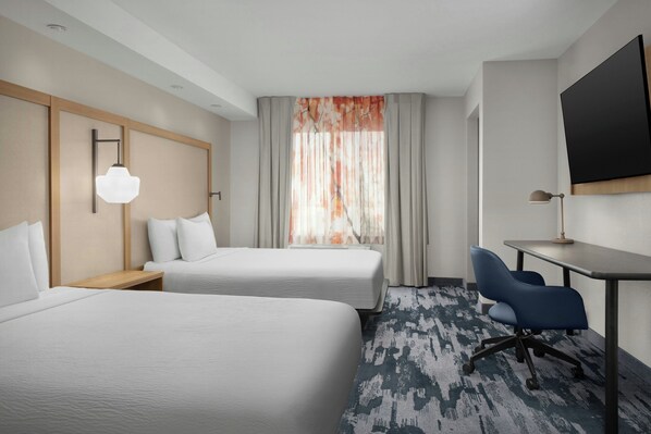 A hotel room with two beds, a desk, a chair, a TV, and a window with curtains. - Fairfield Inn & Suites by Marriott El Centro (El Centro)