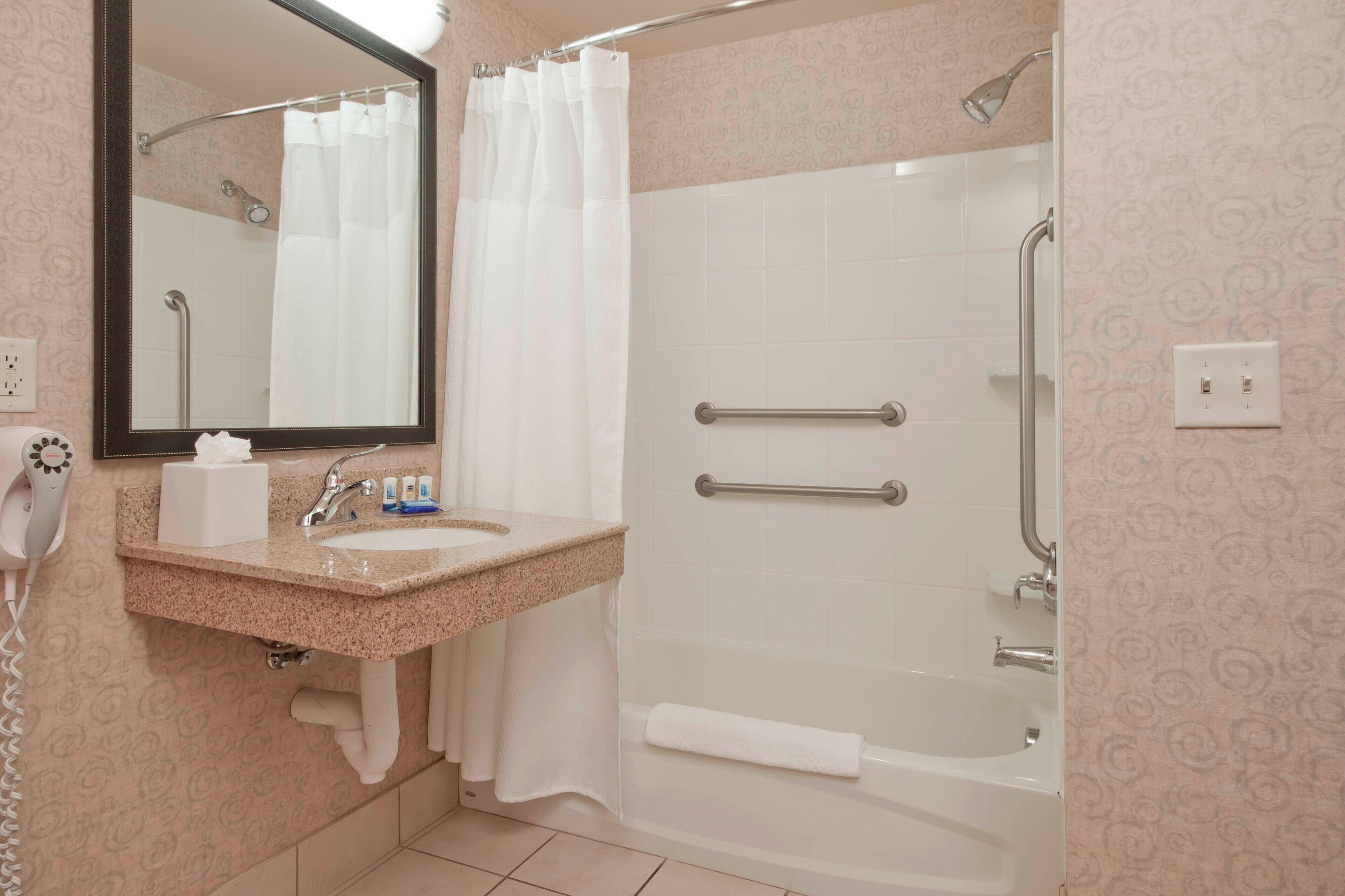 combined shower/bathtub, designer toiletries, hair dryer, towels