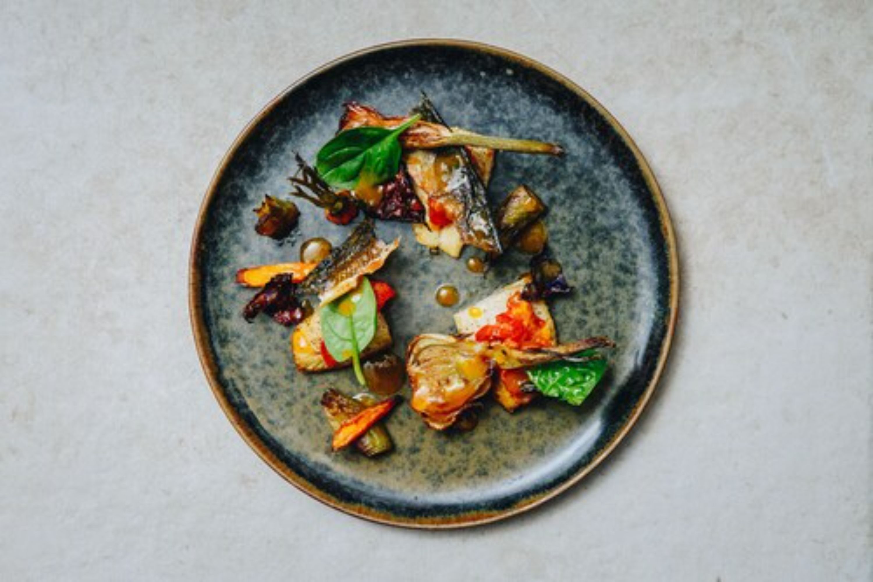 A plate of food with various vegetables and greens.
