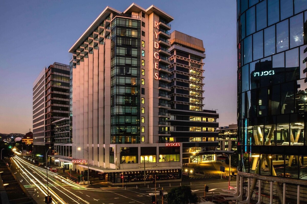 A multi-story hotel with a modern design, featuring a prominent 'RYDGES' sign on the facade.