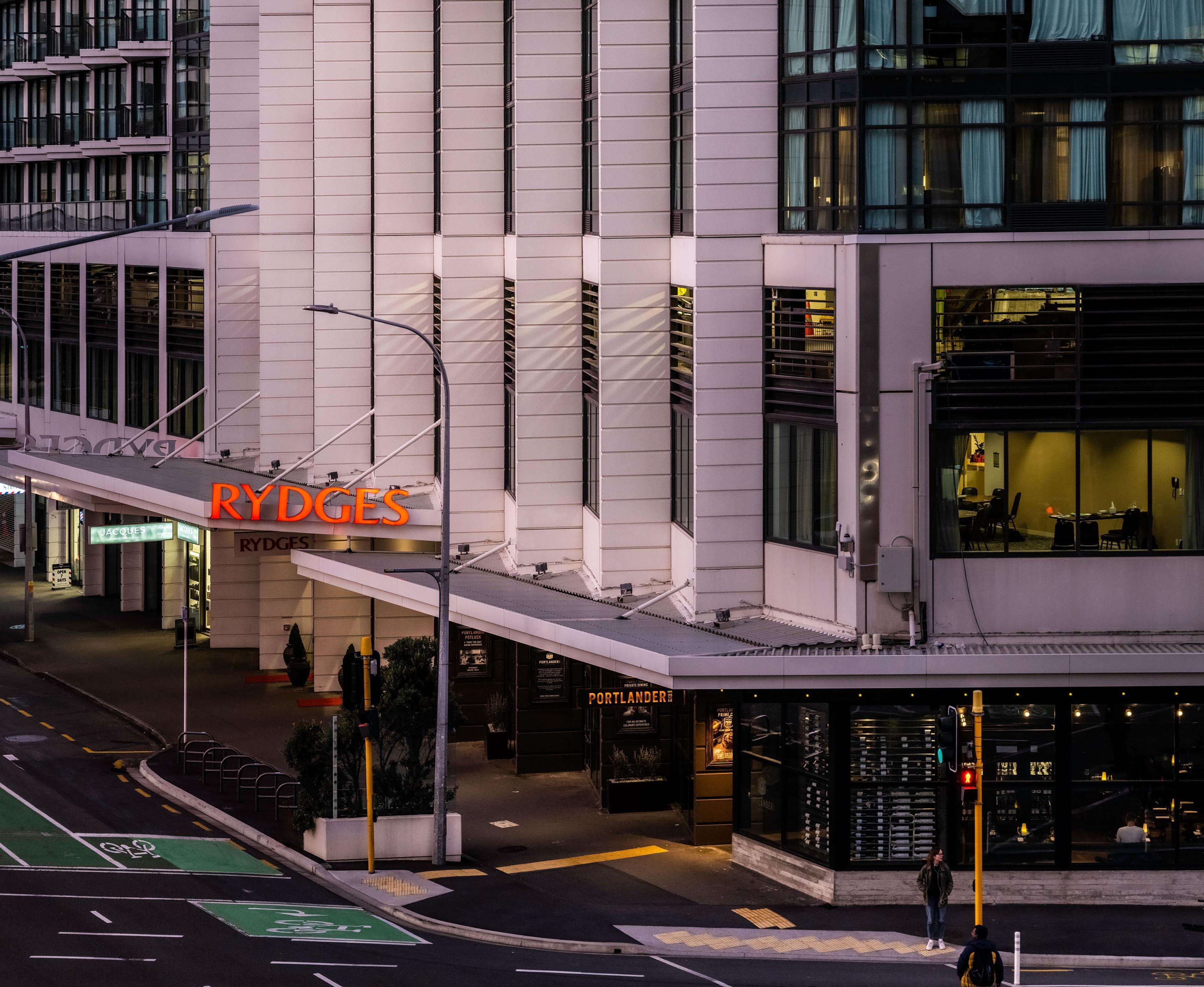 A modern building with a prominent 'RYDGES' sign, a covered entrance, and a visible storefront.
