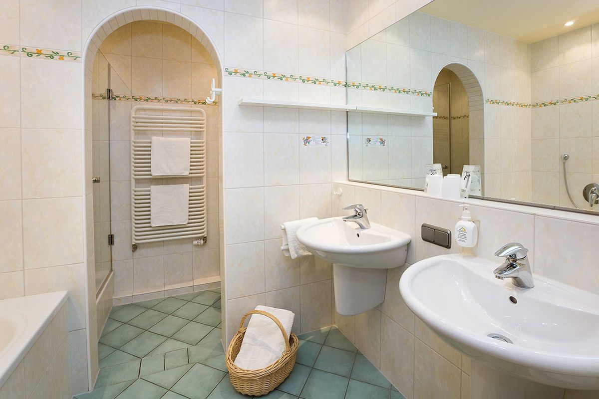 standard double room | bathroom | deep-soaking bathtub, free toiletries, hair dryer, dressing gowns