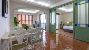 A hotel room with a dining area, a bed, and a bathroom. - Kantary Bay Hotel, Phuket (Wichit)