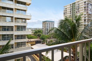 A multi-story residential building with balconies, a central courtyard, and surrounding greenery. - Ewa Hotel Waikiki (Honolulu)