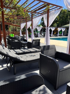 Outdoor pool, open 11:00 AM to 7:00 PM, pool loungers