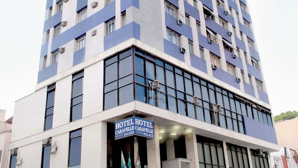 A tall hotel building with a sign reading "HOTEL HOTEL CARAVEL PALACE". - Caravelle Palace Hotel (Curitiba)