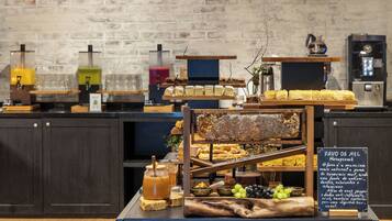 A buffet setup with various food items and a honeycomb display.