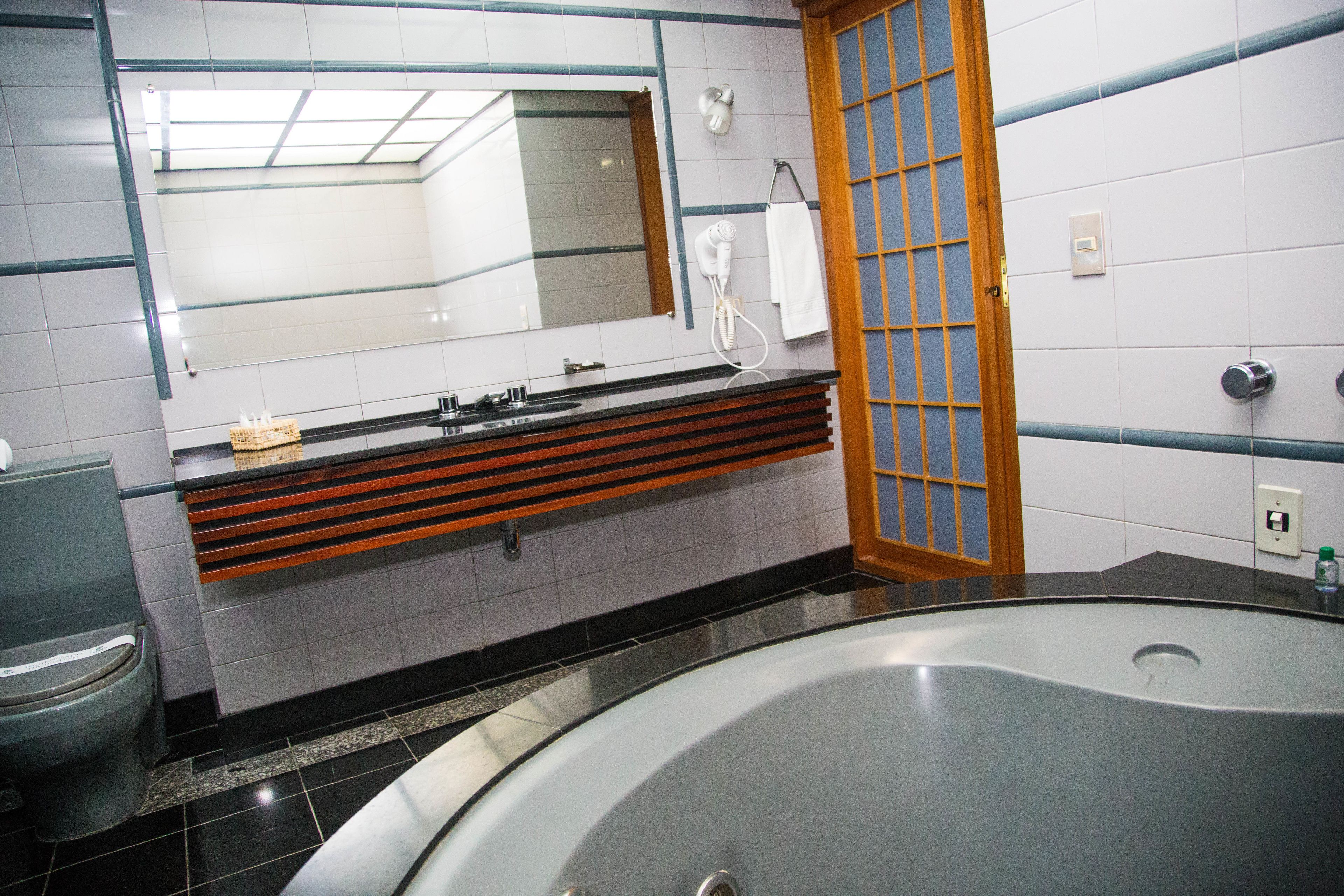 luxury suite, jetted tub | bathroom | shower, free toiletries, hair dryer, bidet