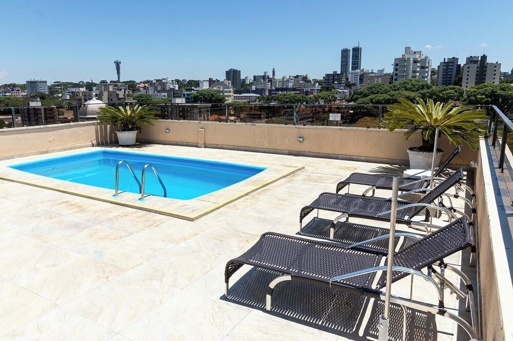 Una piscina al aire libre, tumbonas