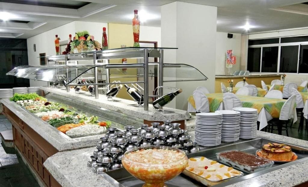 A buffet setup with various food items and drinks.