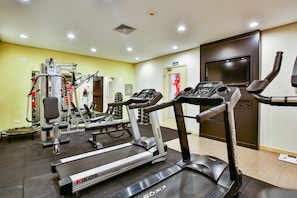 Stay active with our well-equipped gym featuring treadmills, a weight machine, and a stationary bike.