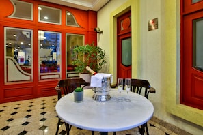 Enjoy a romantic dinner for two at this cozy dining area, complete with a round table and a beautiful potted plant.
