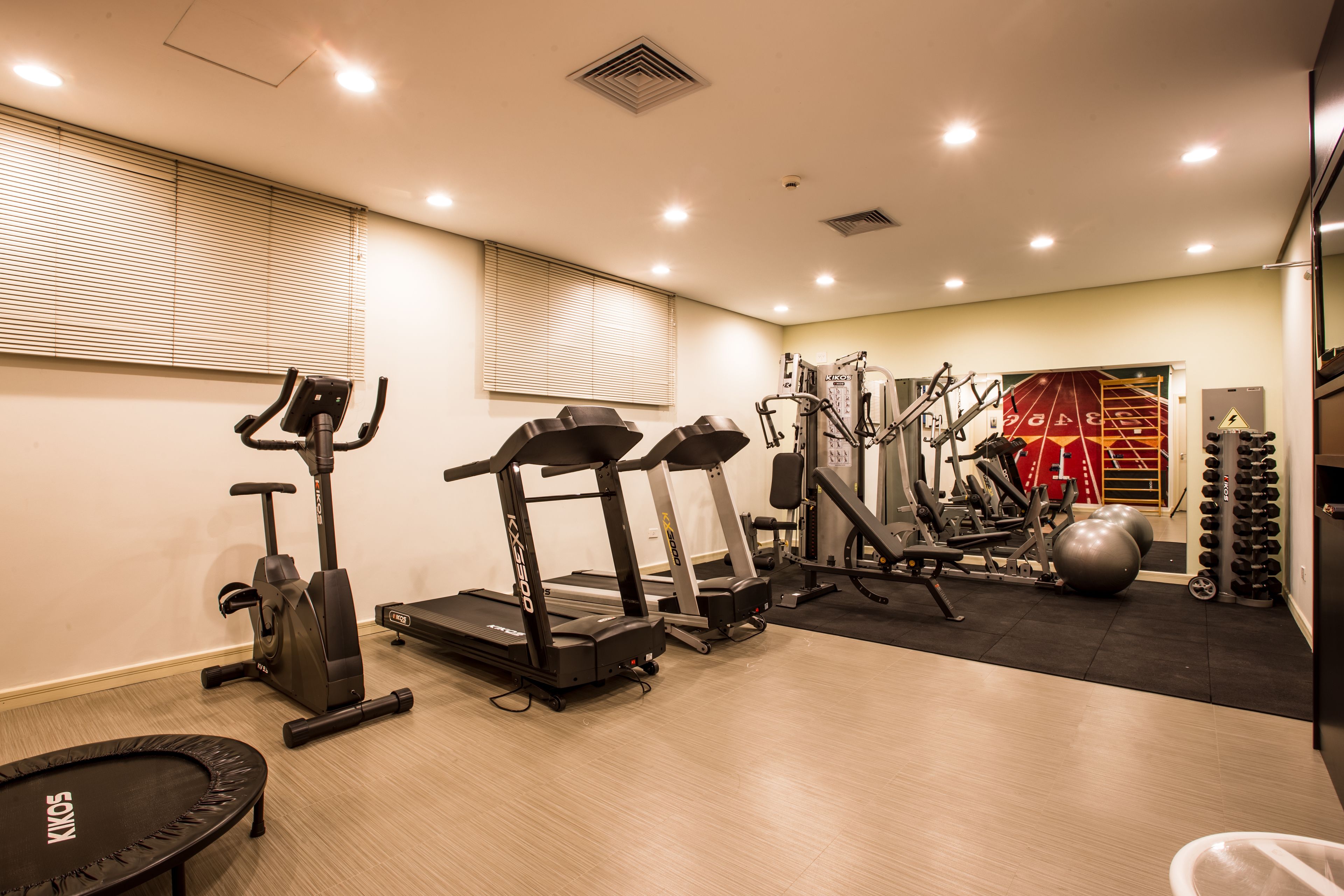 A gym with treadmills, elliptical machines, and weight equipment.