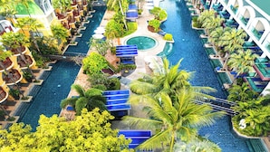 A resort with multiple swimming pools, palm trees, and sun loungers. - Phuket Graceland Resort And Spa (Patong)