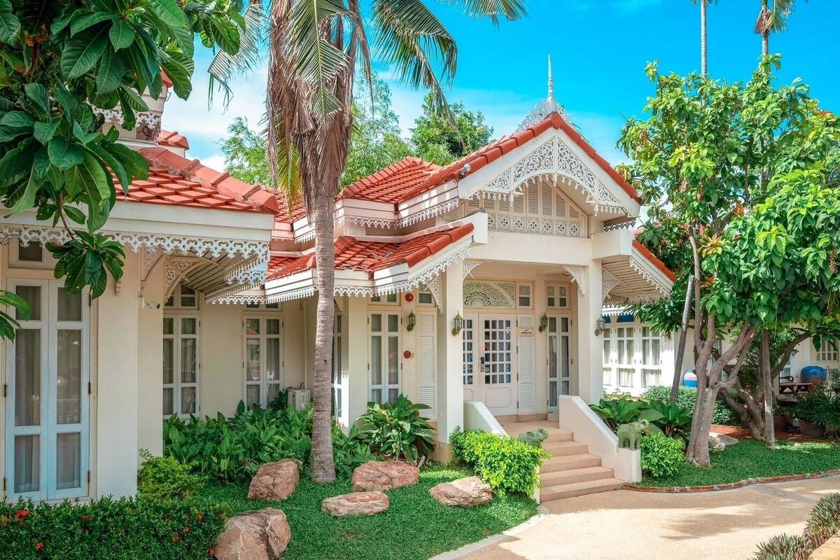 A traditional building with a red-tiled roof, white walls, and intricate architectural details.