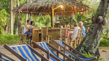 Relax in a serene tropical setting surrounded by lush greenery.