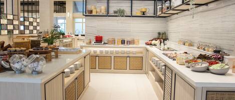 A buffet setup with various food items and condiments.