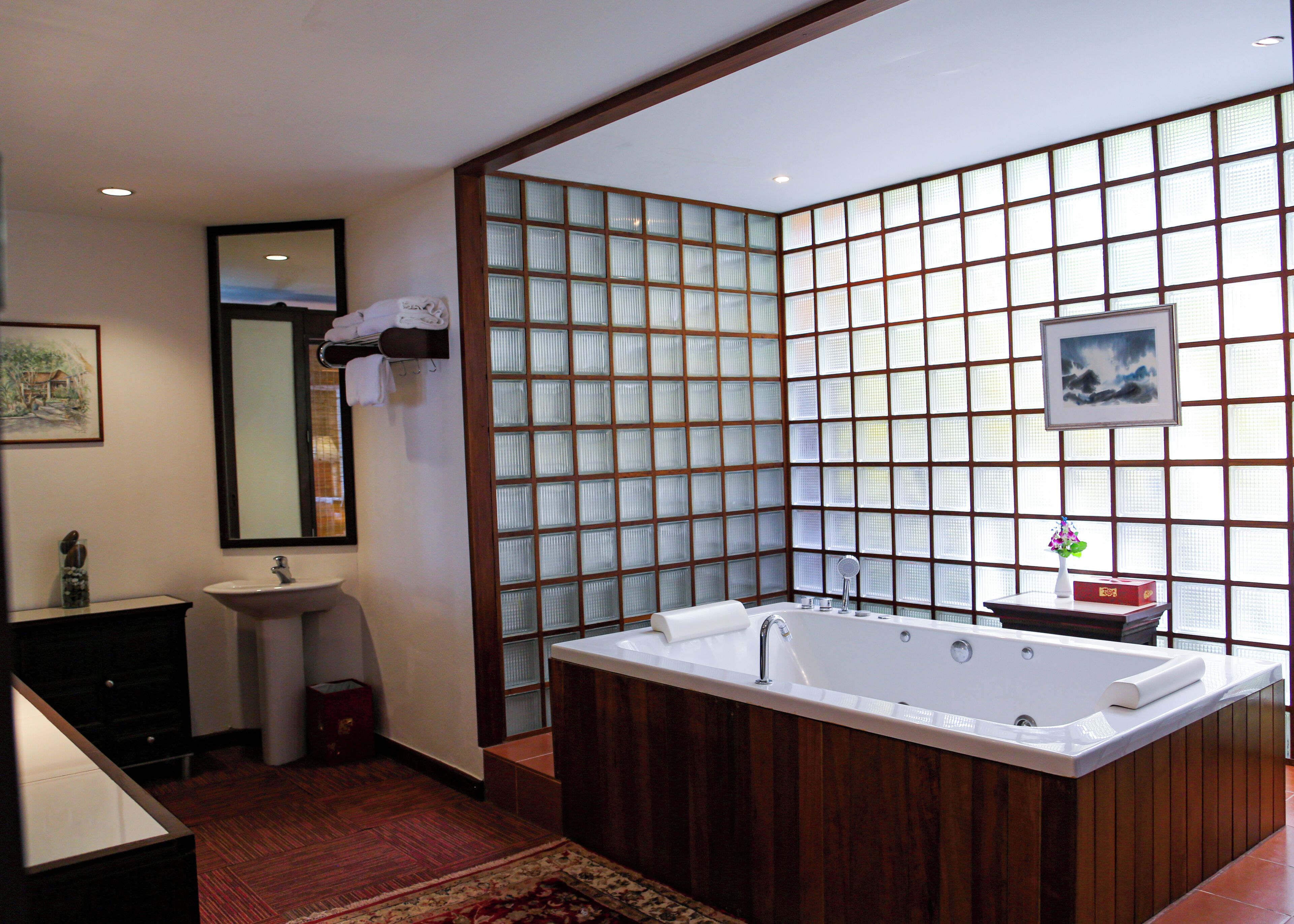 A modern bathroom with a freestanding bathtub, a sink, and a mirror.