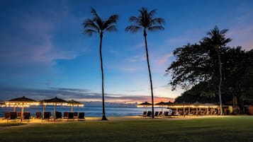 On the beach, white sand, beach umbrellas, beach towels