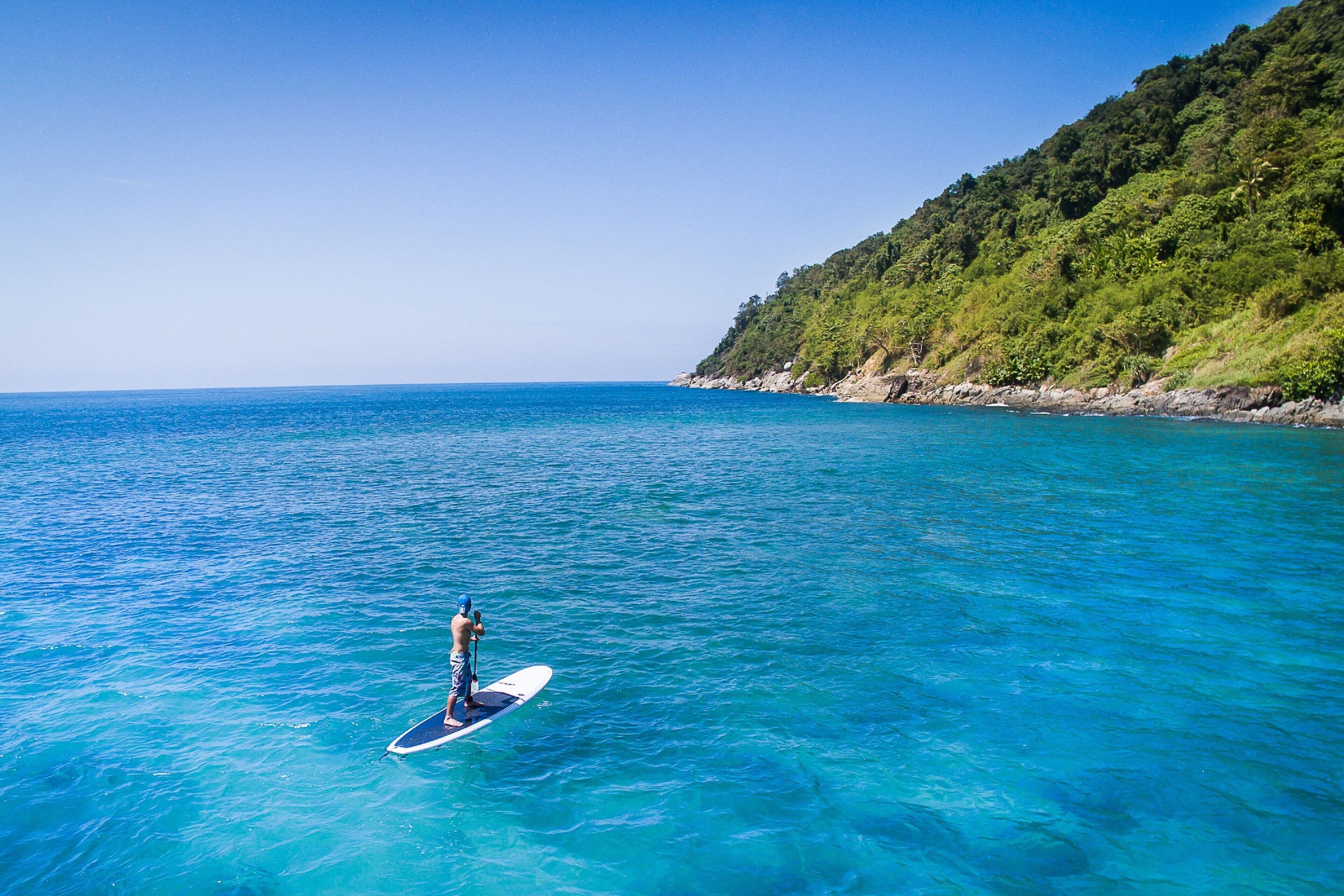 on the beach, white sand, beach umbrellas, beach towels