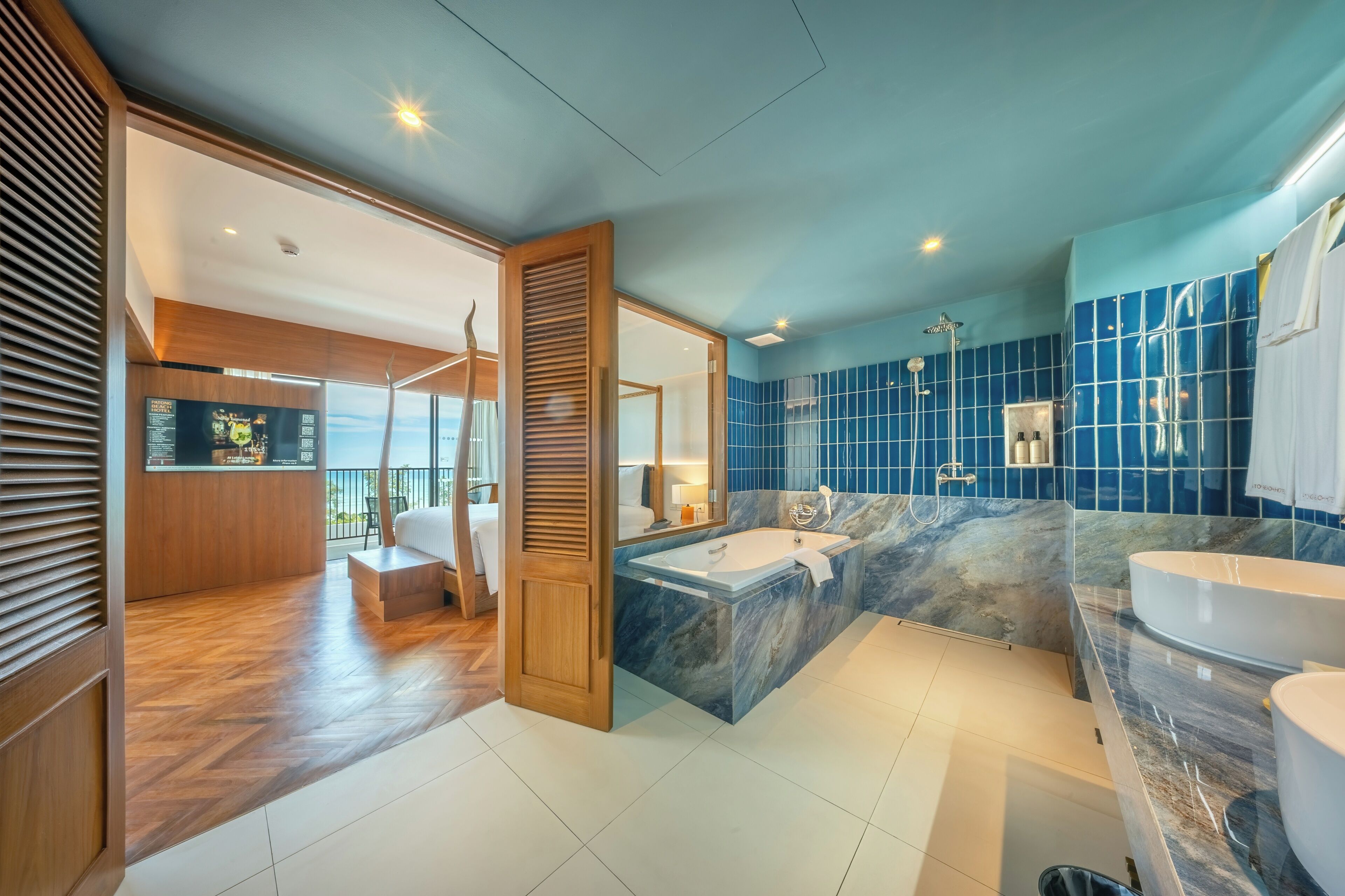 A modern bathroom with a large bathtub, a separate shower area, and a vanity with a marble countertop.