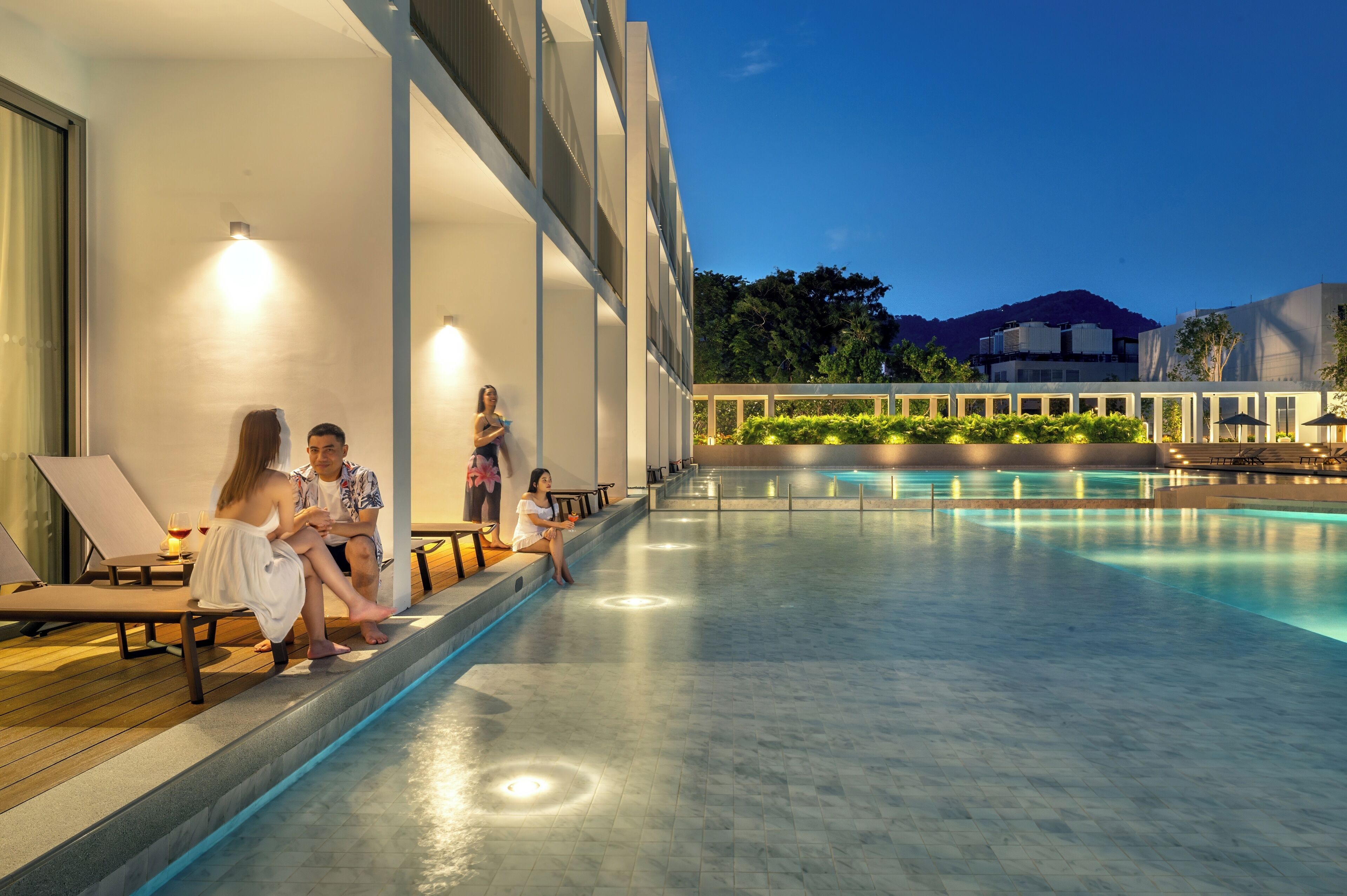 A poolside area with lounge chairs and a pool.