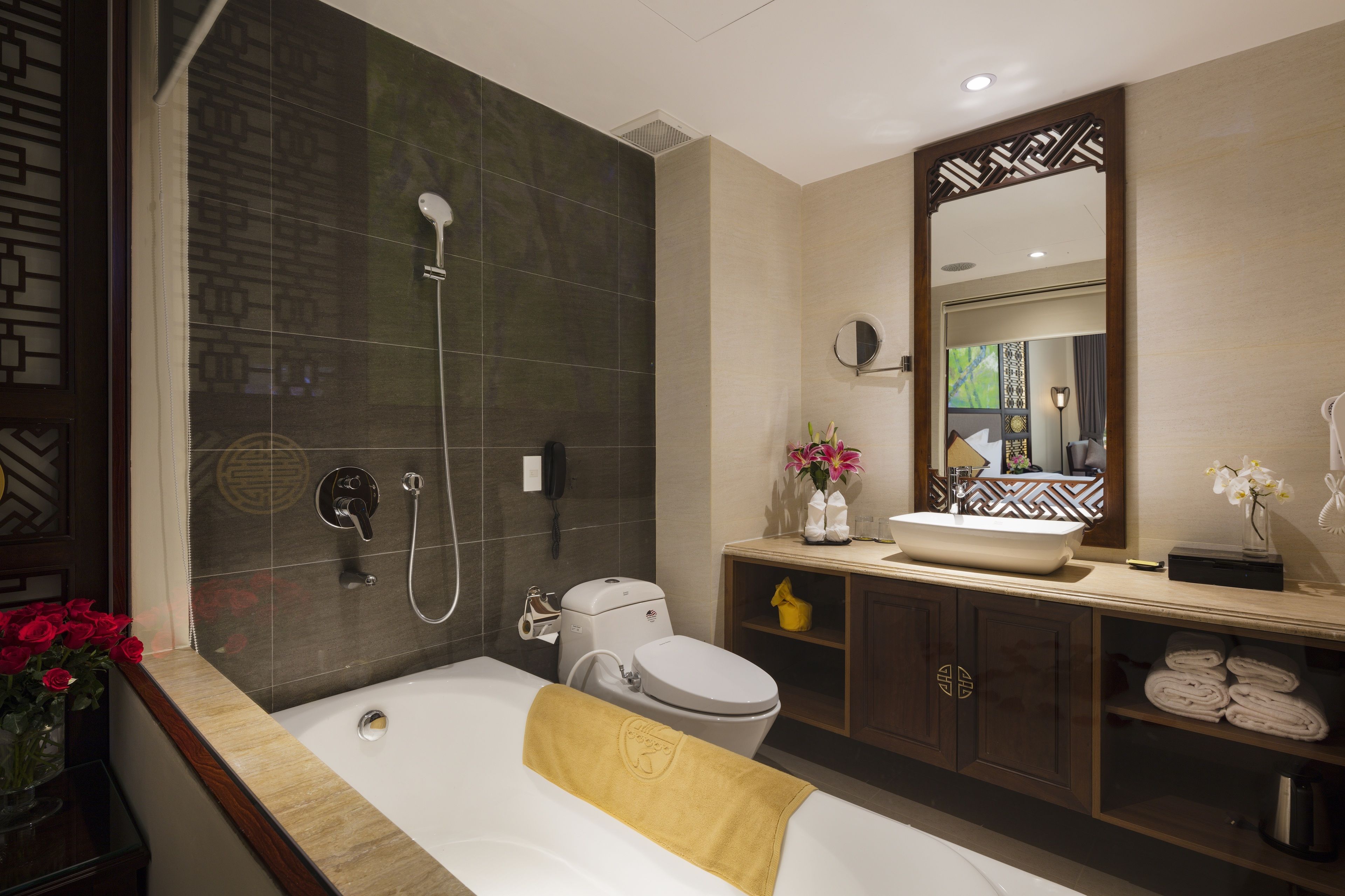 A modern bathroom with a bathtub, a toilet, a sink, and a shower.