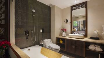 A modern bathroom with a bathtub, a toilet, a sink, and a shower.