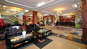 A spacious lobby with a grand staircase, a reception desk, and seating areas. - Duy Tan Hotel (Hue)