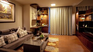 A modern living room with a sofa, coffee table, and decorative items. - Asia Hotel Hue (Hue)